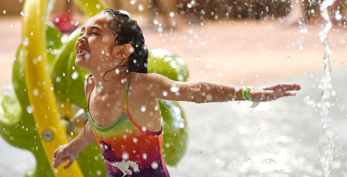 Little girl enjoying cub paw pool