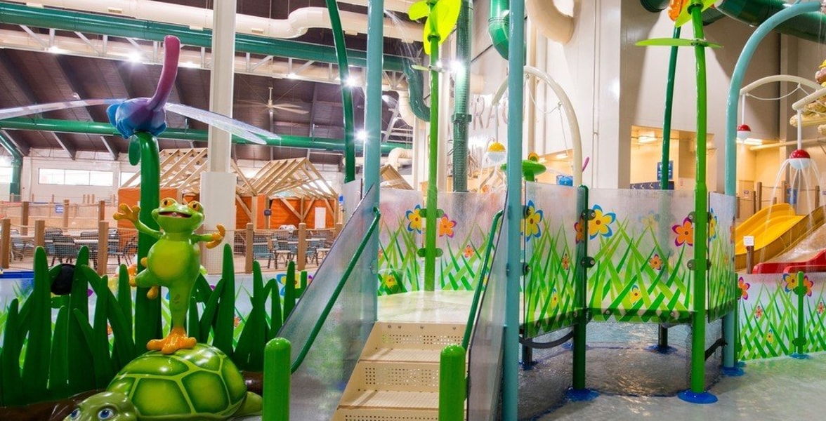 A vibrant water park featuring a large slide and a fun water play area for children.
