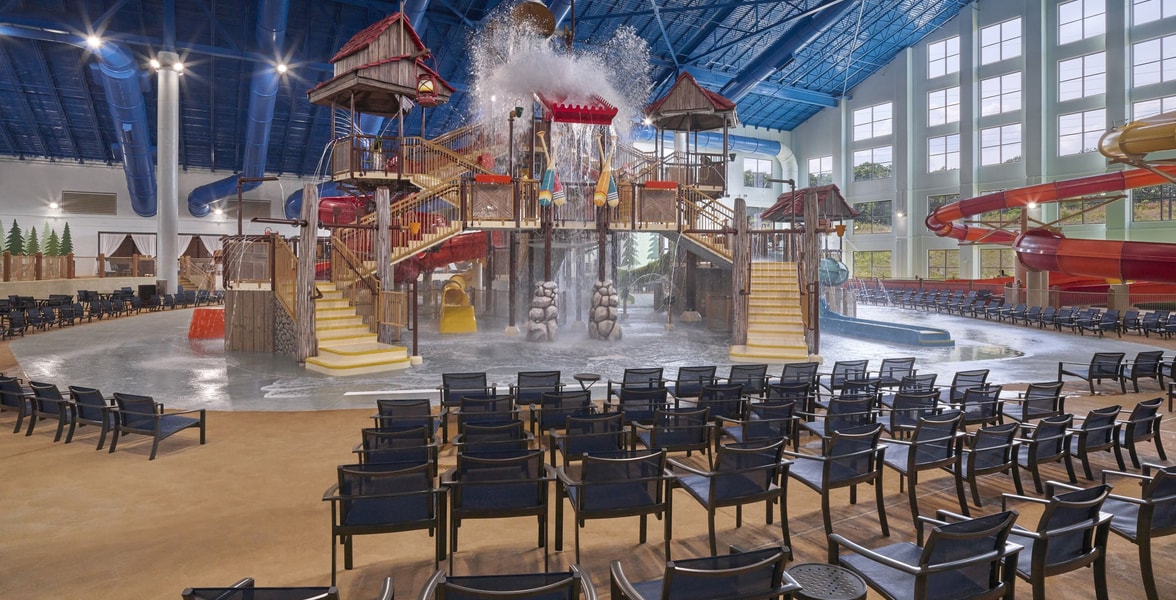 A wide shot of the water treehouse as water splashes down from a bucket