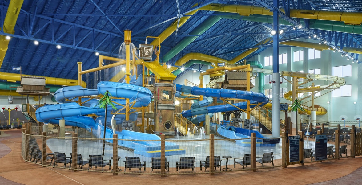 A wide shot of the water treehouse as water splashes down from a bucket