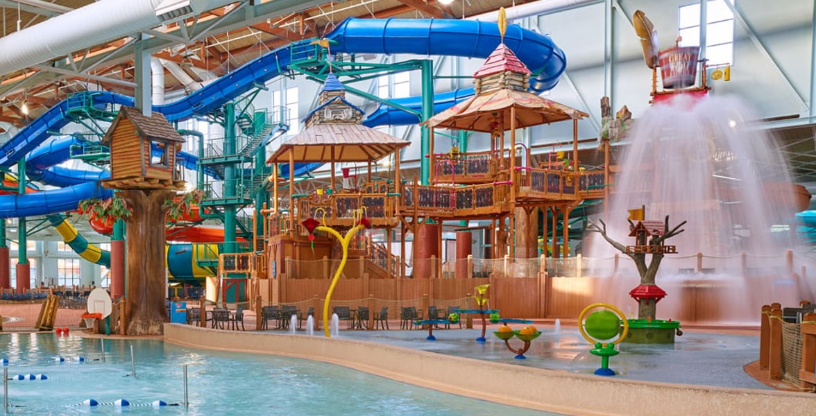 A wide shot of the water treehouse as water splashes down from a bucket