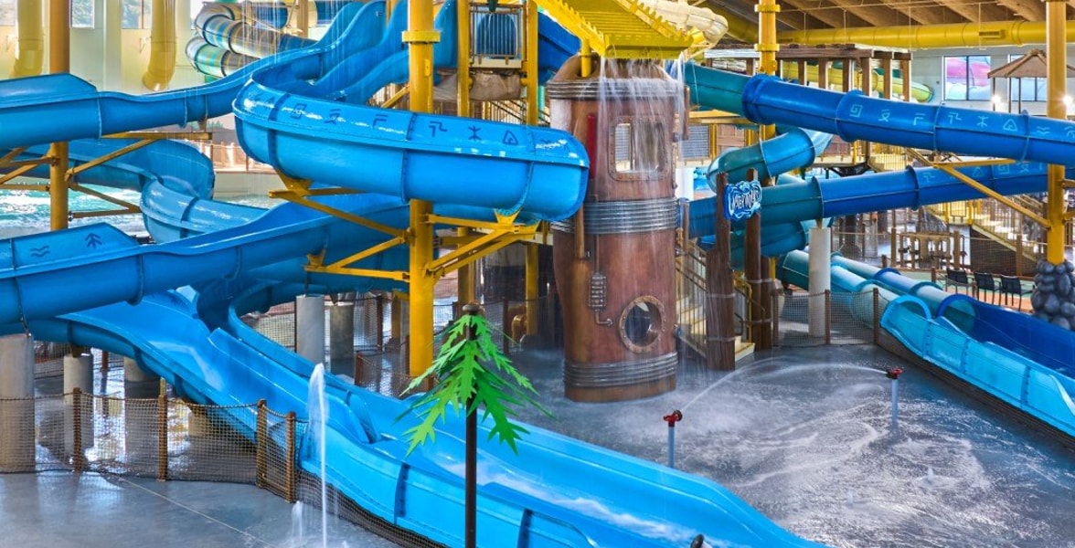 A wide shot of the water treehouse as water splashes down from a bucket