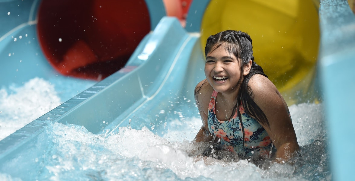 Teen going down a body water slide