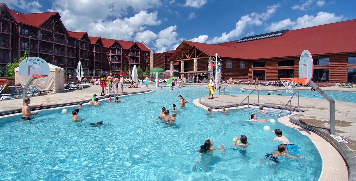 guests playing basketball in an outdoor pool