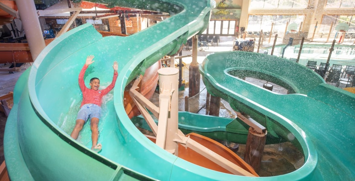 kid rides down waterslide