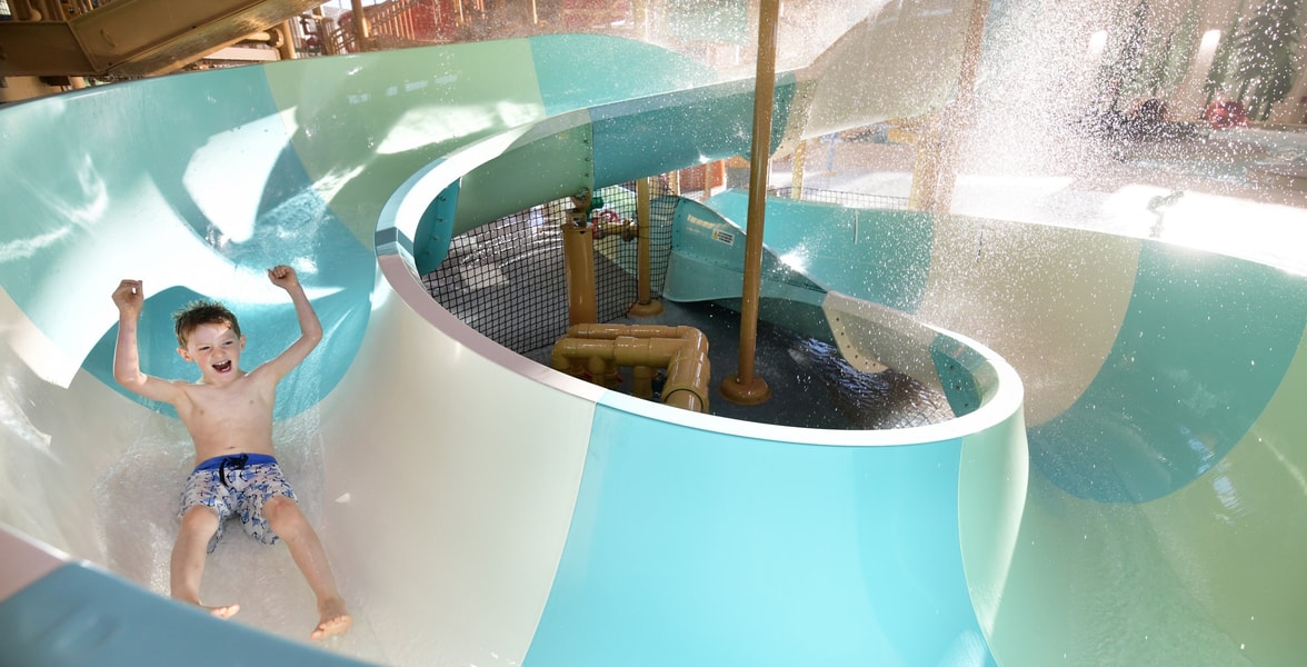 kid rides down waterslide