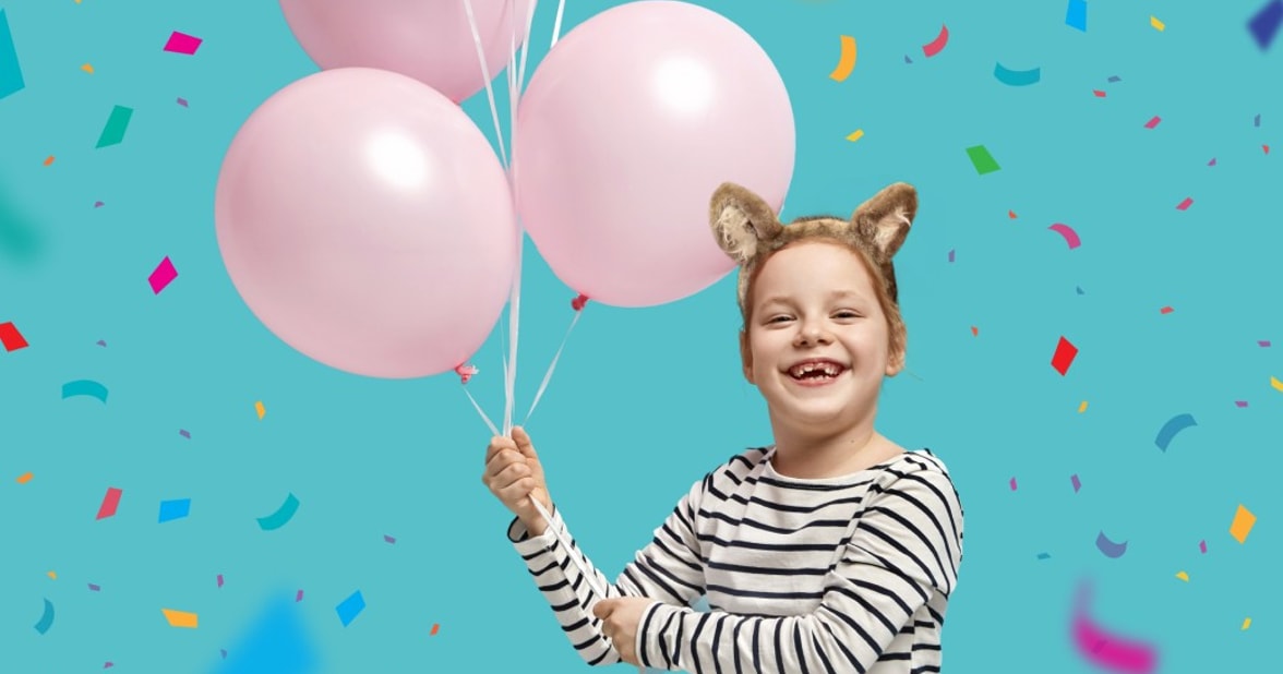 Girl with balloons at birthday party at Great Wolf Lodge