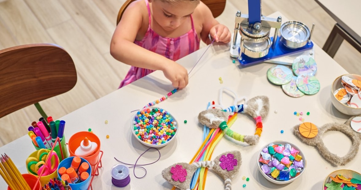 Girl making a string of beads