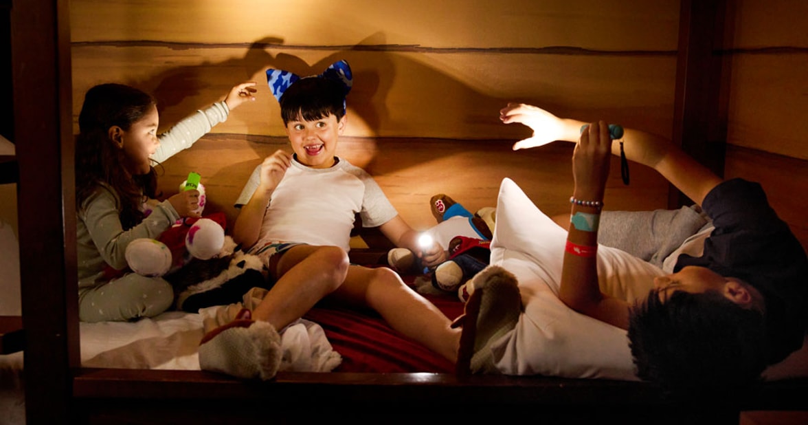 three kids playing in a bunk bed