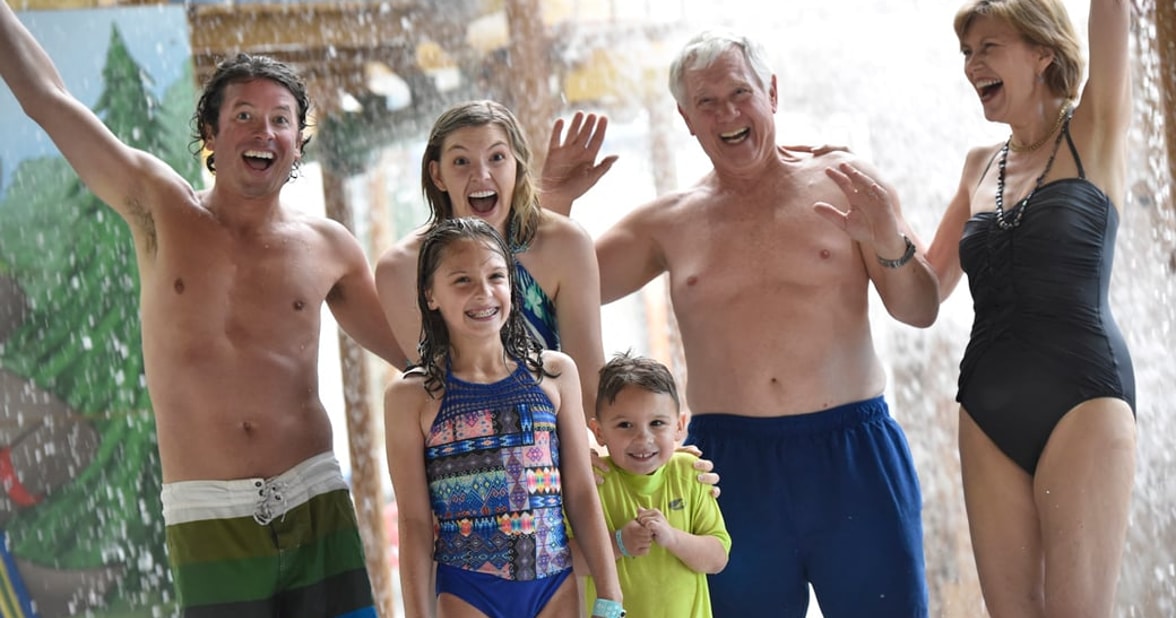 family enjoying water park attractions