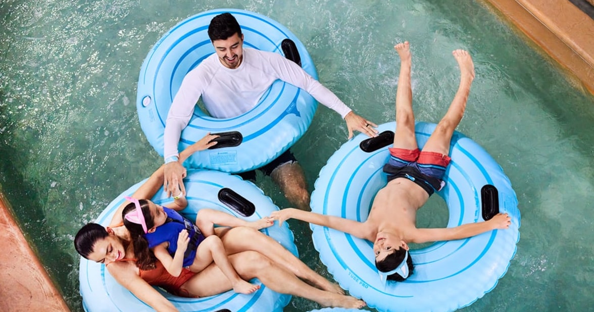 family in a lazy river pool