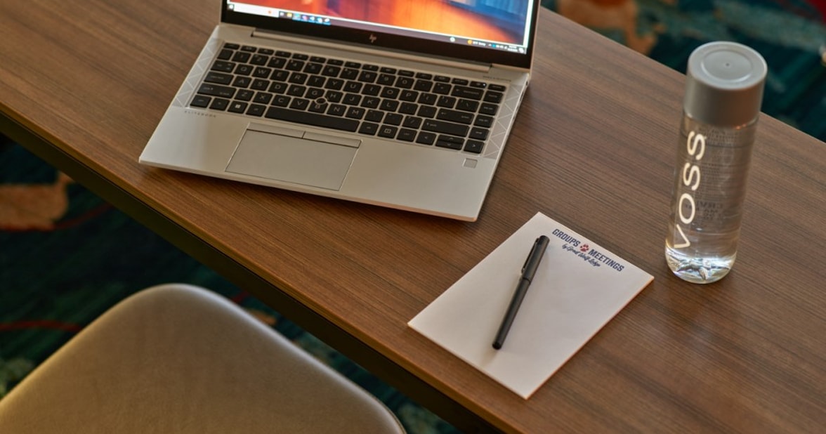 Laptop and writing pad on a table