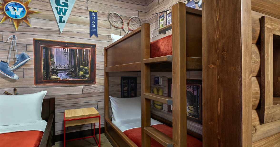 bunks beds and a day bed in a cabin themed suite