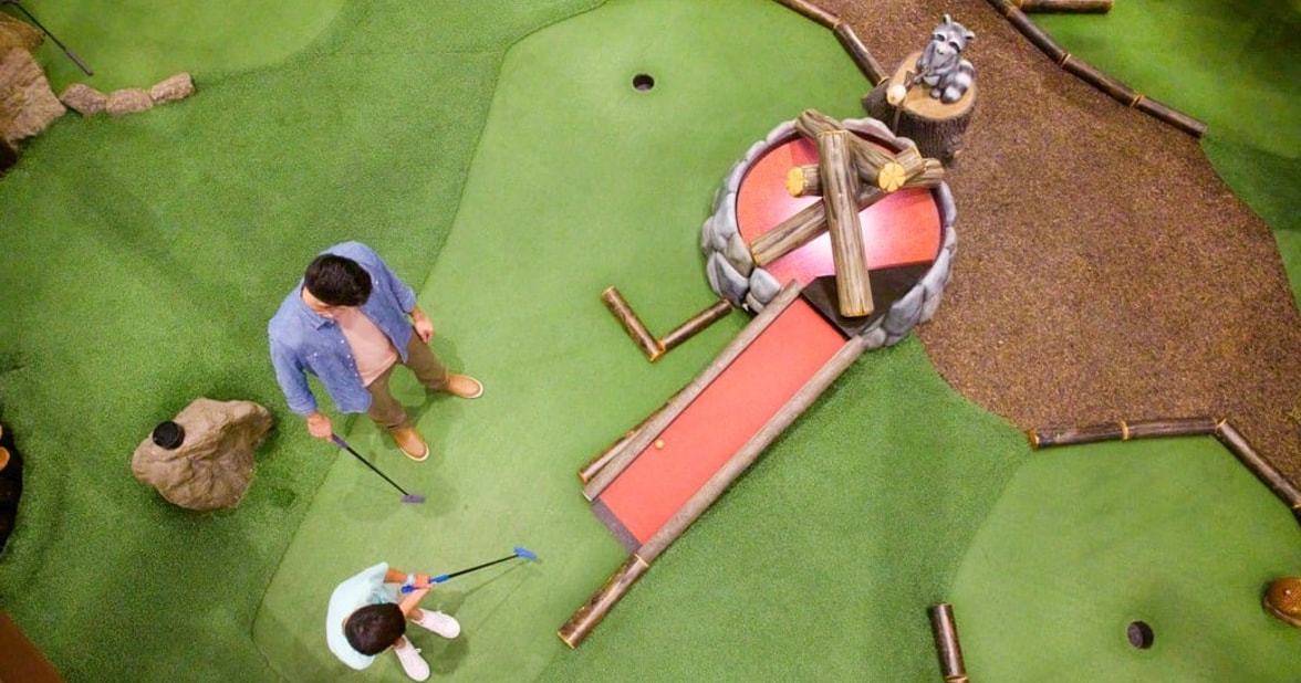 guests playing a game of mini golf