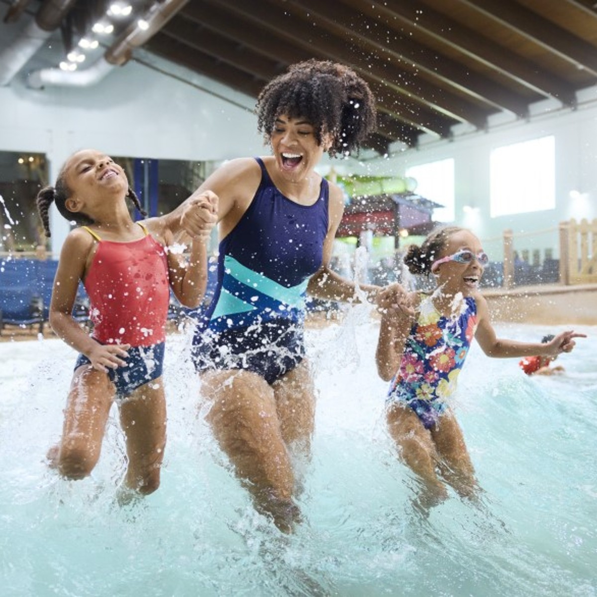 Kids with their mother jumping in the pool