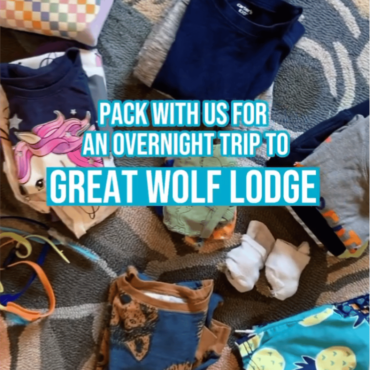 two kids seating in front of a big Christmas tree