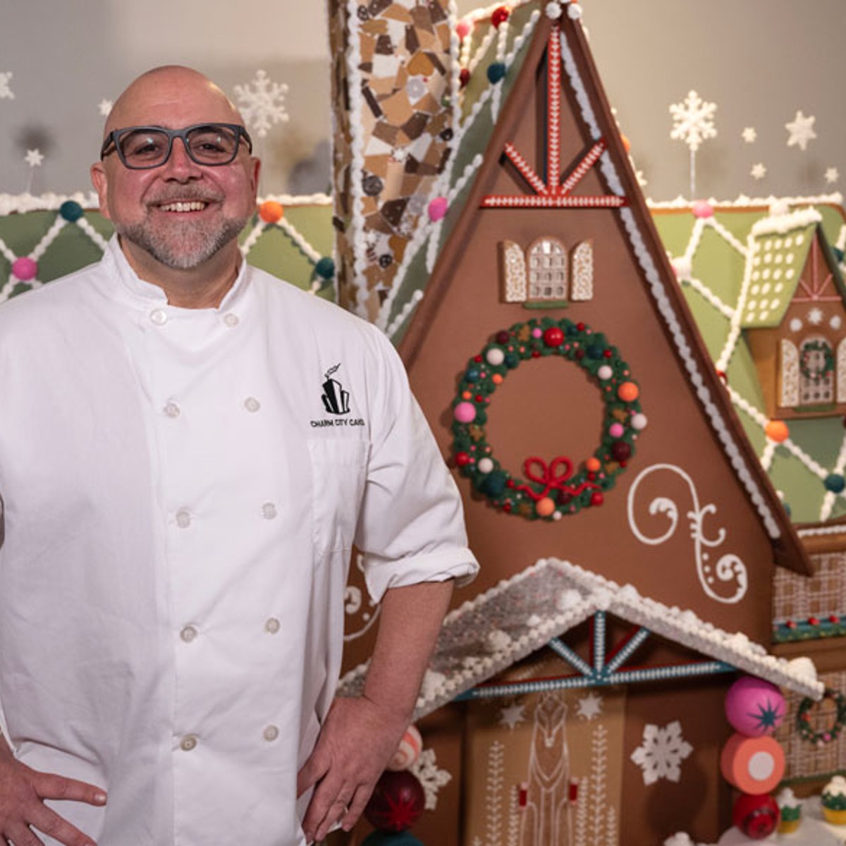 duff goldman standing in front of gingerbread house maryland