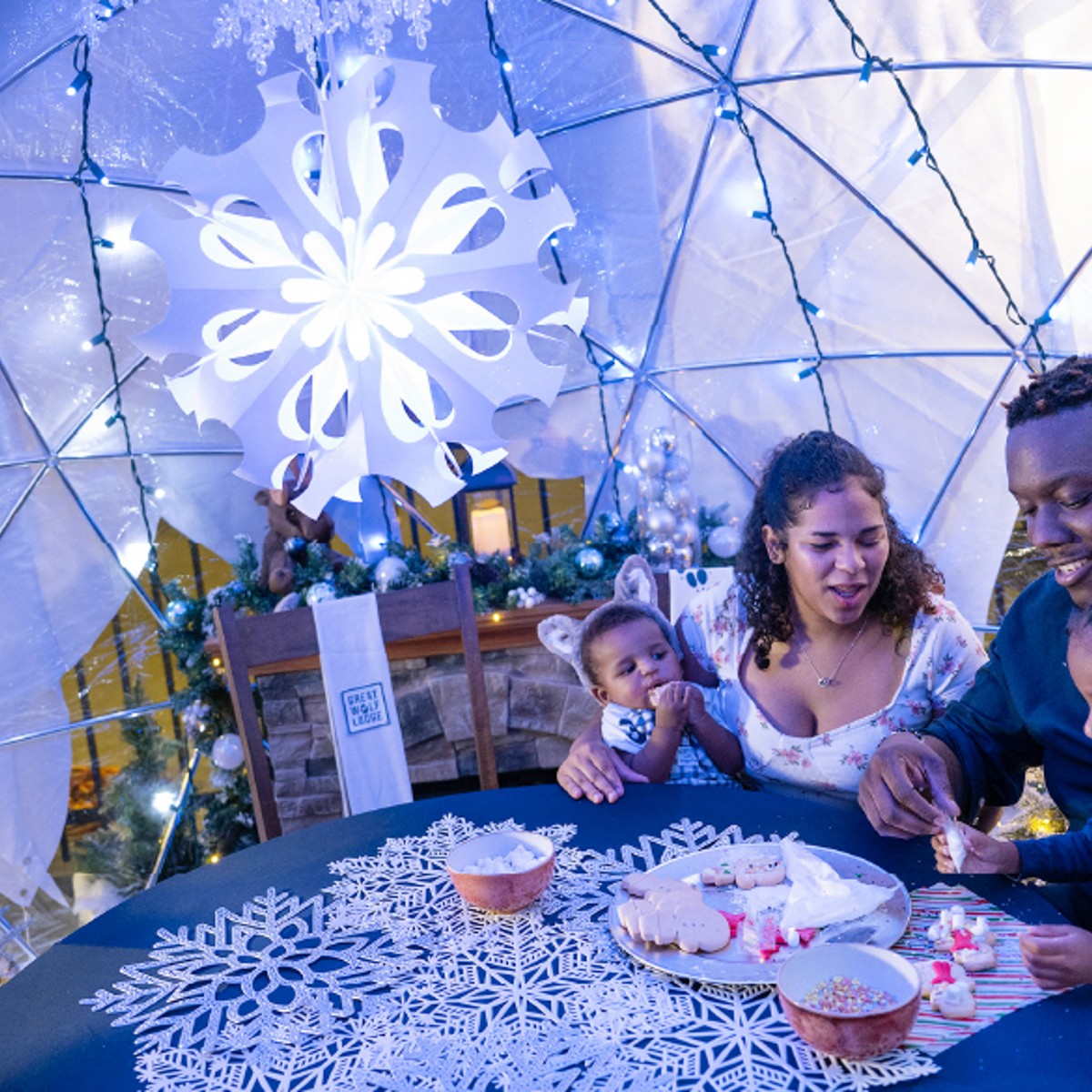 family enjoying time in a snow globe
