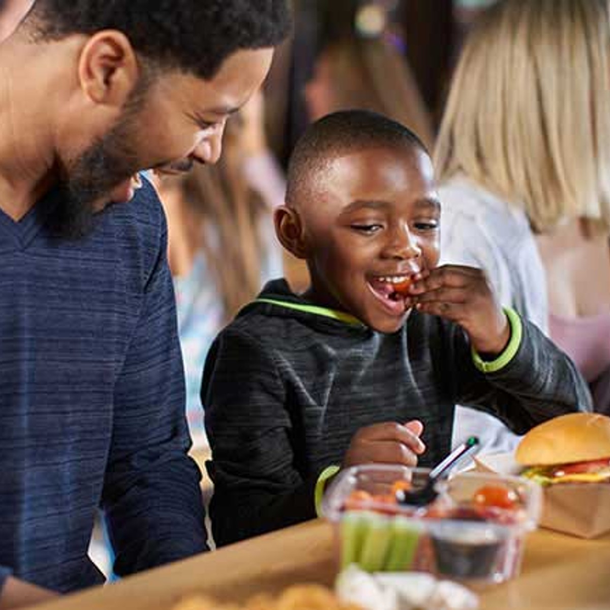 father and son having lunch
