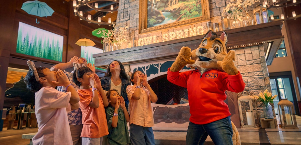 Great Wolf Lodge mascots posing in front of entrance statue