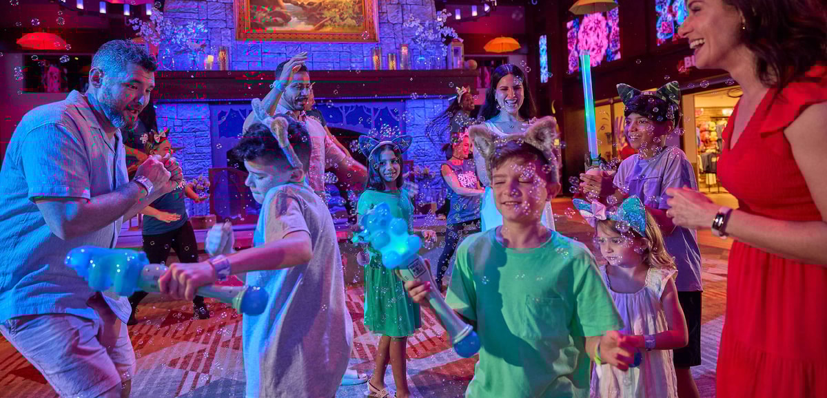 A family dancing and playing with bubbles in a fun setting