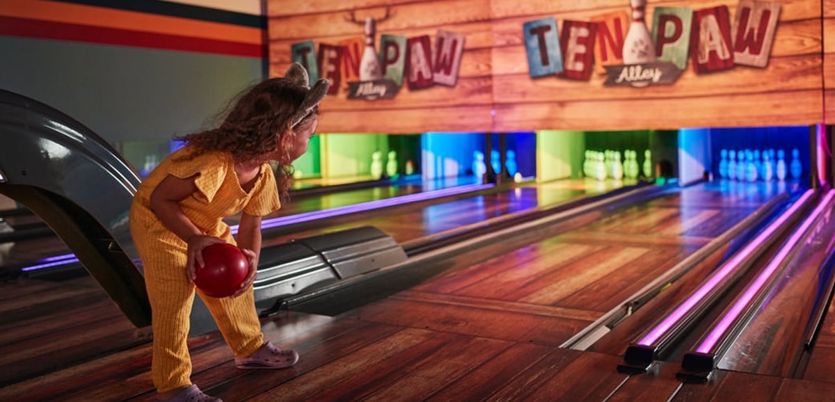 Girl enjoying at Ten Paw Alley at Great Wolf Lodge indoor water park and resort.