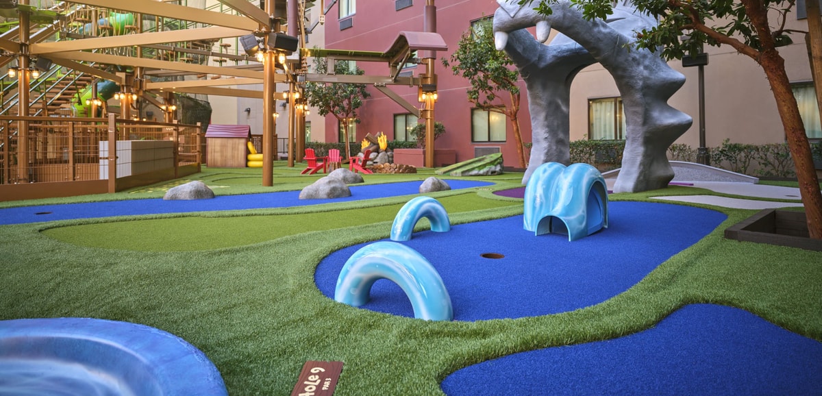 Overhead shot of a family playing mini golf