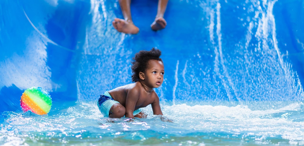 toddler playing in a kiddie pool