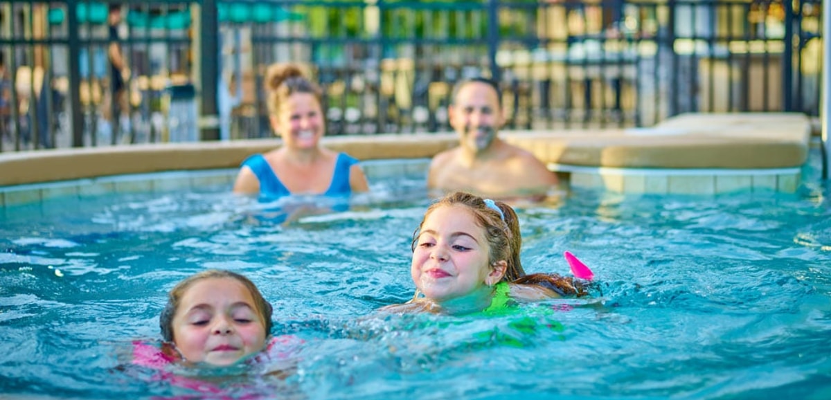 Kids and family having fun in pool