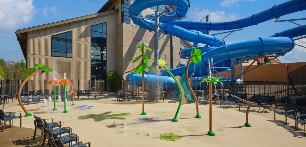 Kids play behind the outdoor water features 