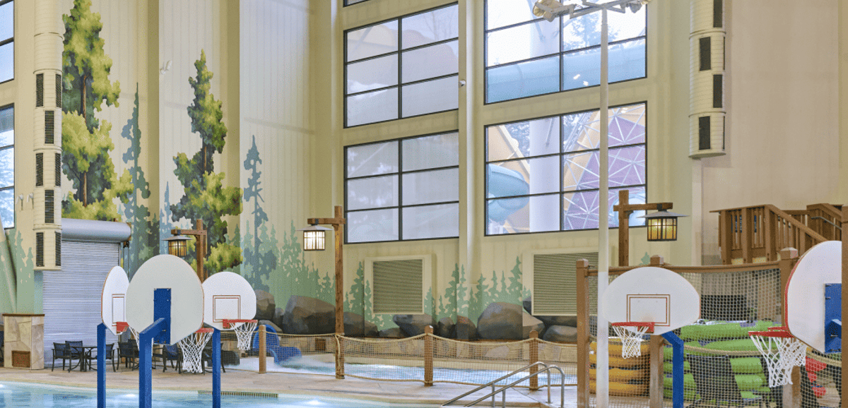 activity indoor pool with basketball hoops