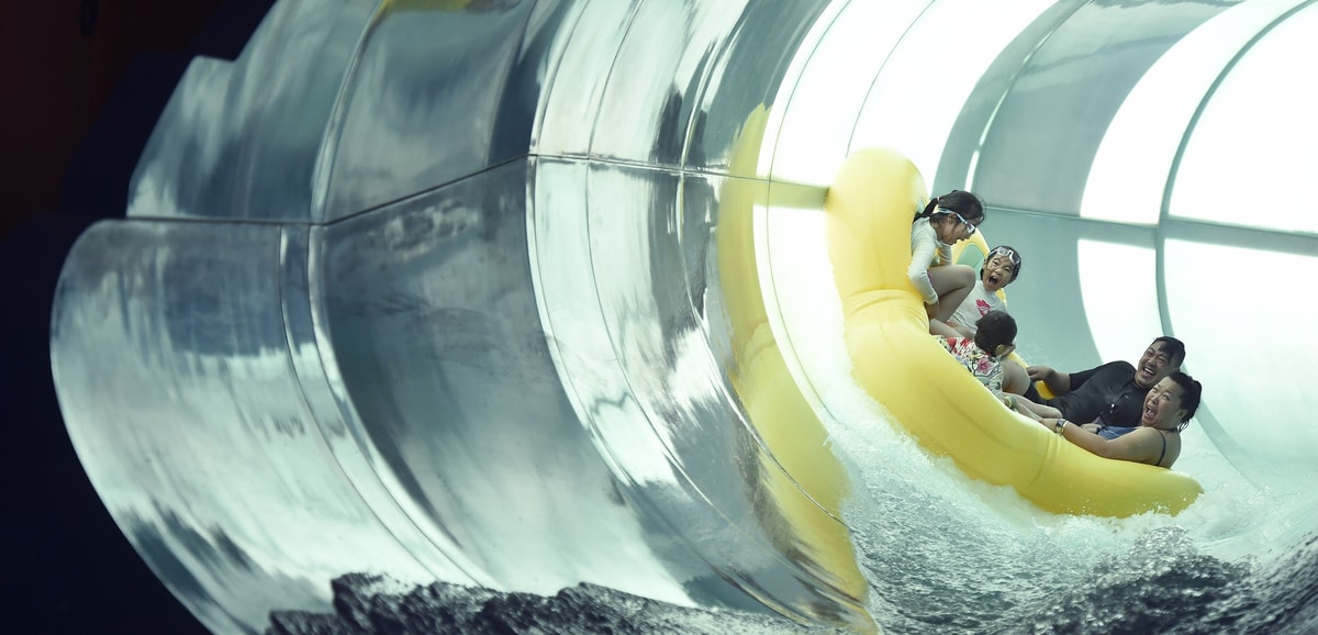 Family of five rides down enclosed water slide 