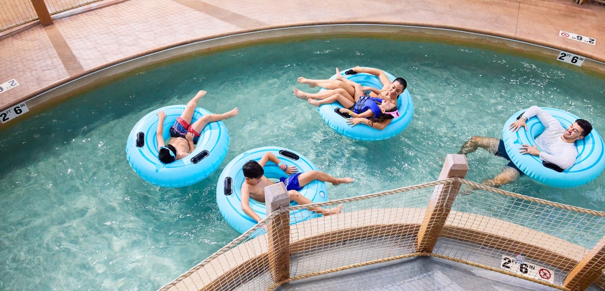 Family riding tubes enjoying the lazy river attraction