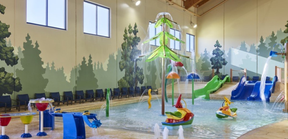 mother and child playing in a kiddie pool