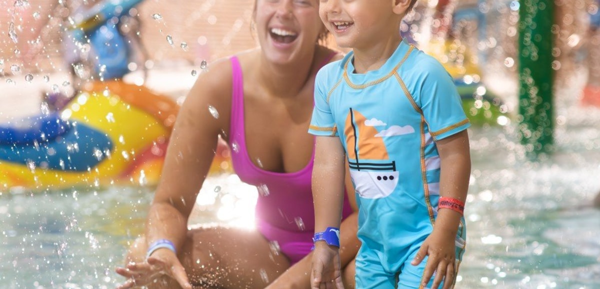 mother and child playing in a kiddie pool