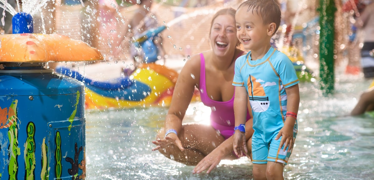 mother and child playing in a kiddie pool
