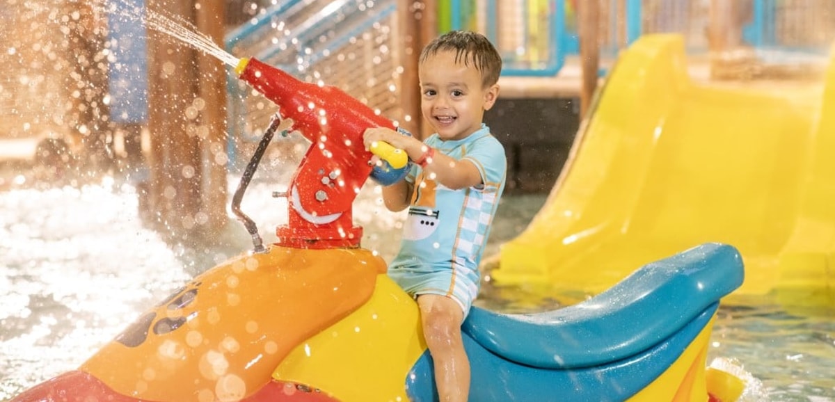 mother and child playing in a kiddie pool