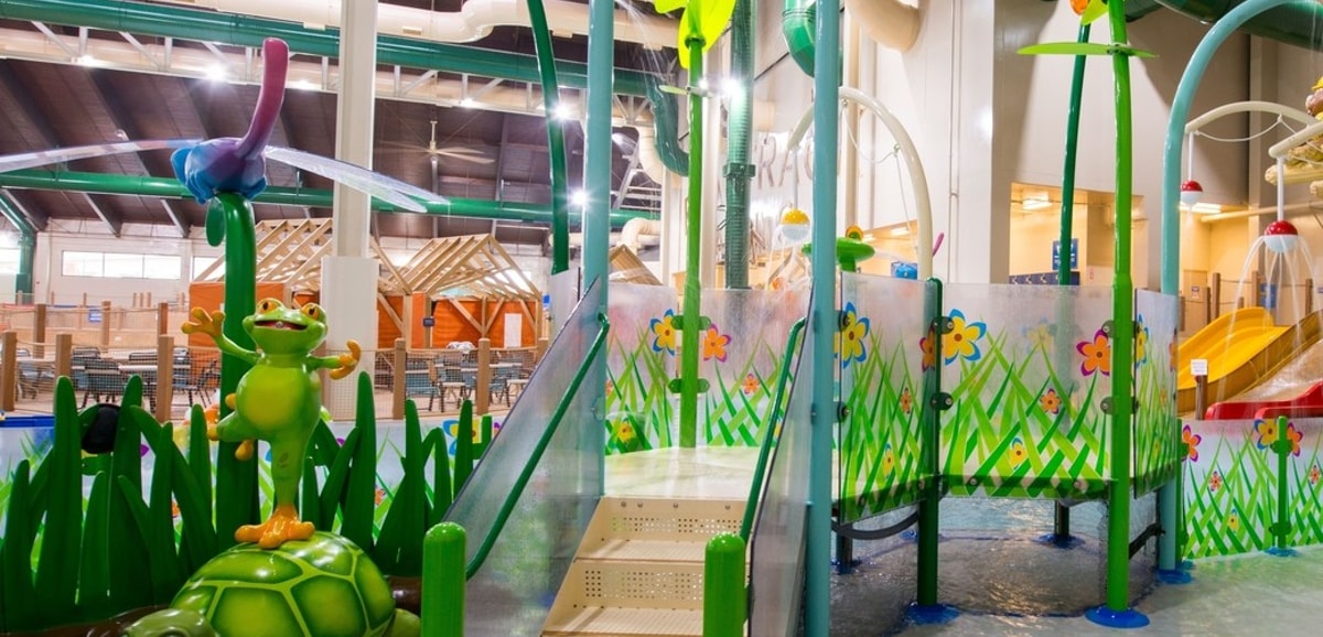 A vibrant water park featuring a large slide and a fun water play area for children.