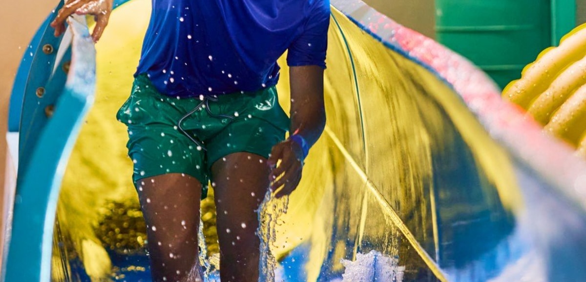 Teen enjoying water slide adventure ride