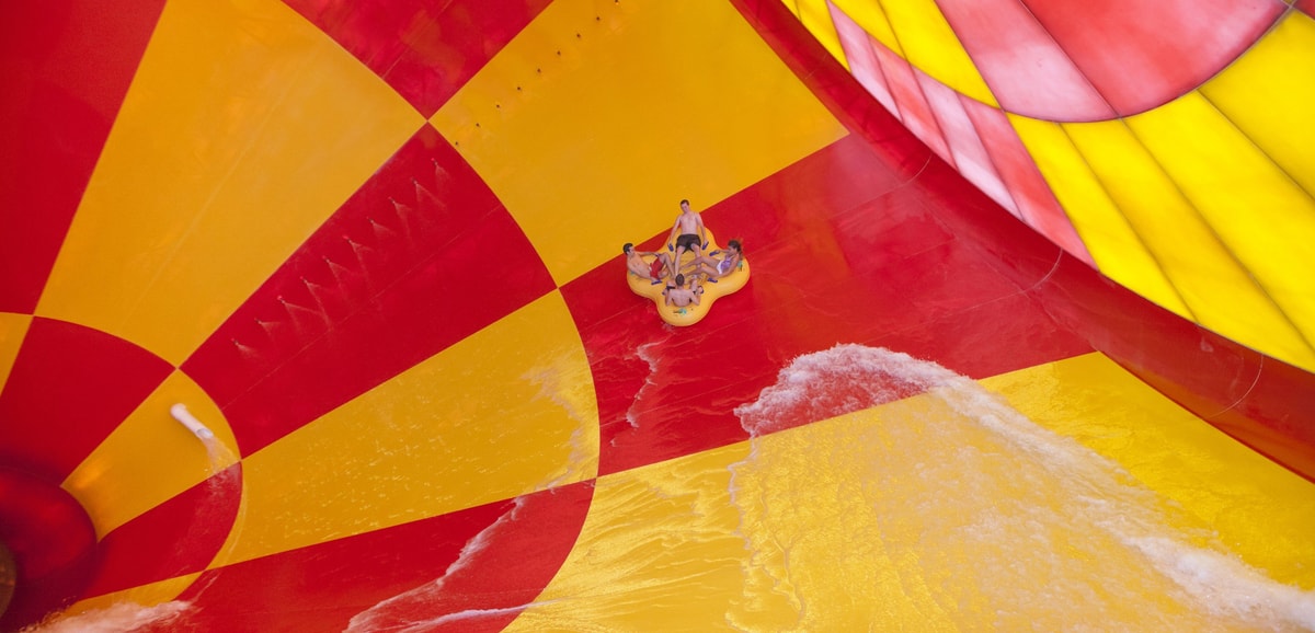 4 people on a 4-person tube riding dwn the howlin' tornado water park ride
