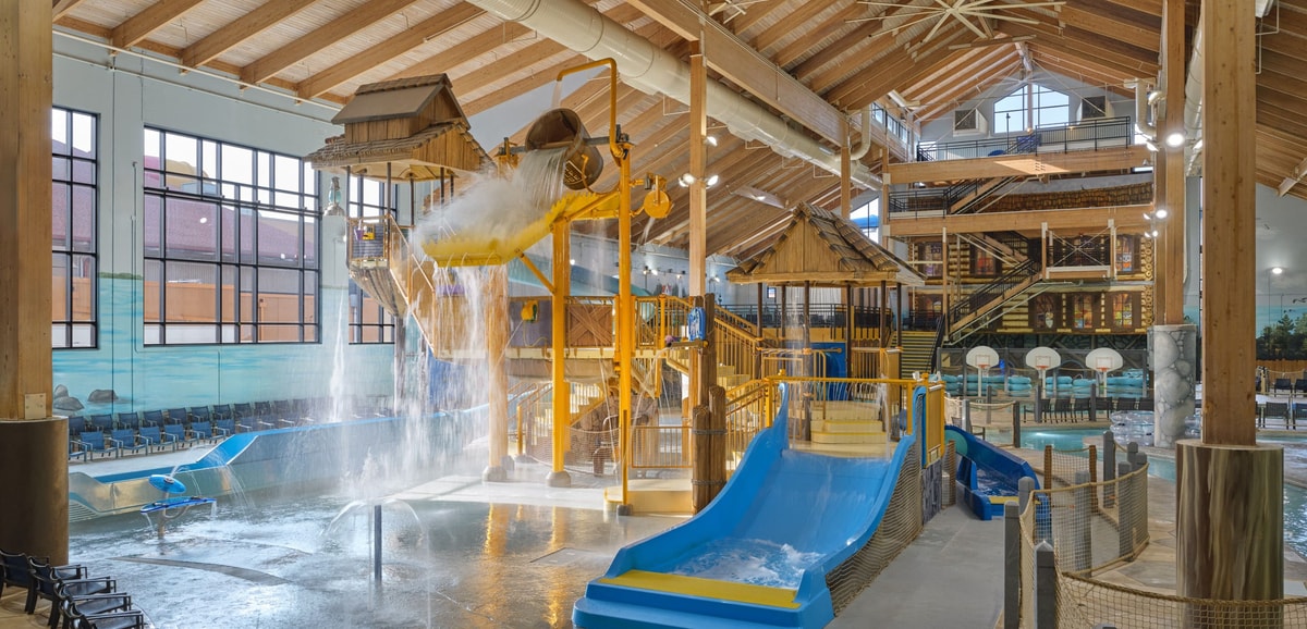 A wide shot of the water treehouse as water splashes down from a bucket