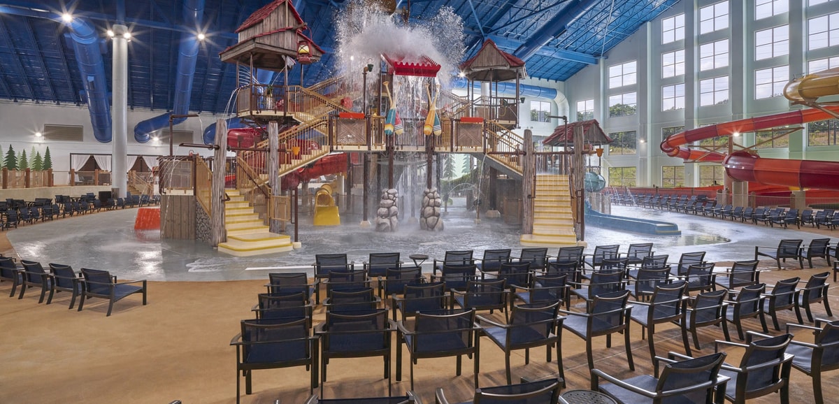 A wide shot of the water treehouse as water splashes down from a bucket