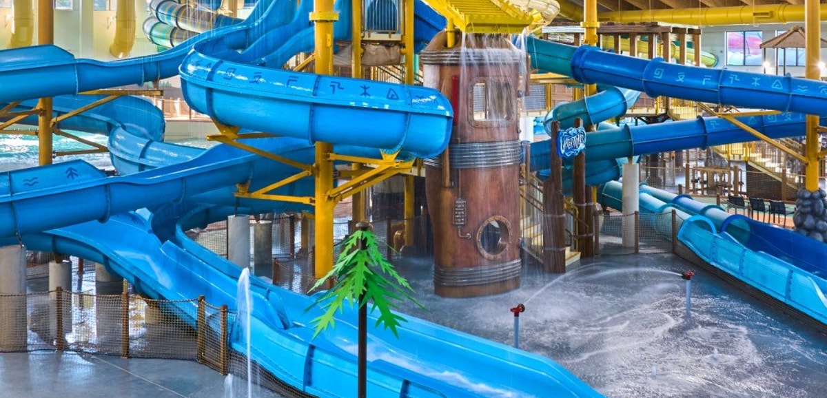A wide shot of the water treehouse as water splashes down from a bucket