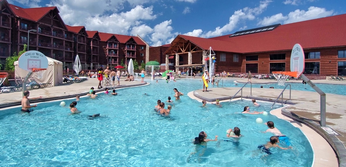 guests playing basketball in an outdoor pool