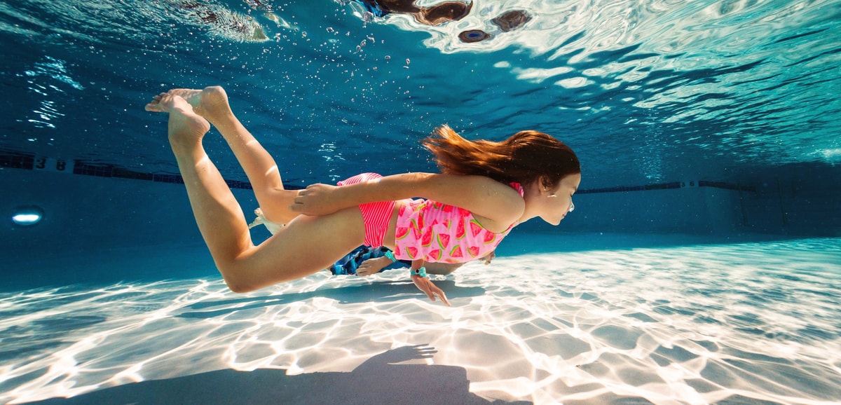 girl swimming under water