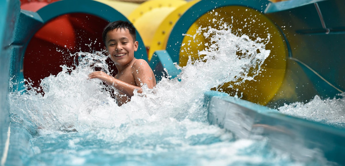 kid rides down waterslide