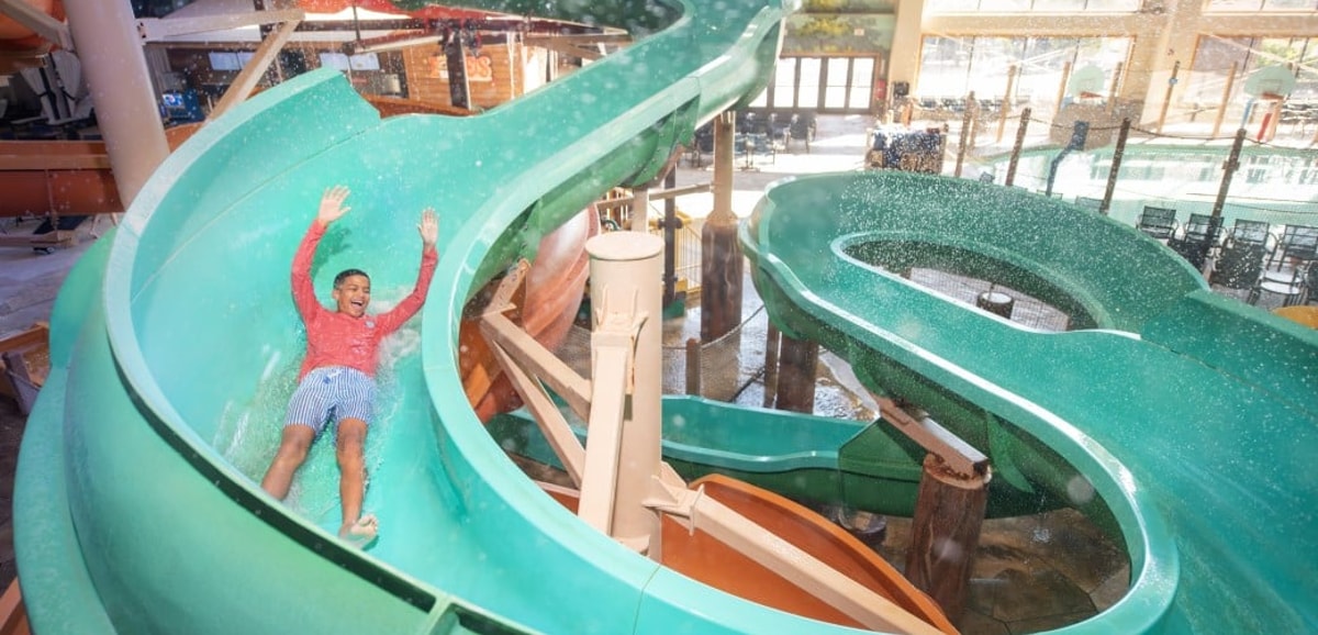 kid rides down waterslide