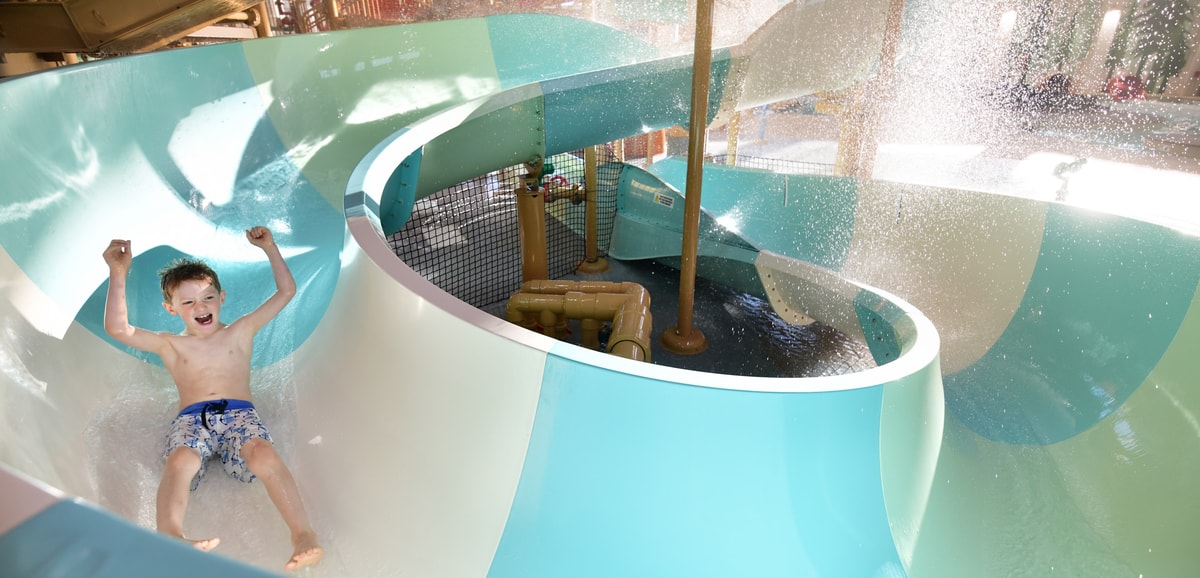 kid rides down waterslide