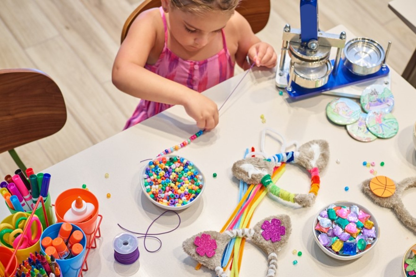 Girl making a string of beads
