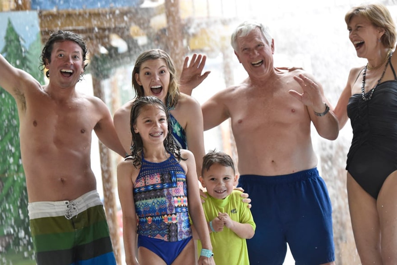 family enjoying water park attractions